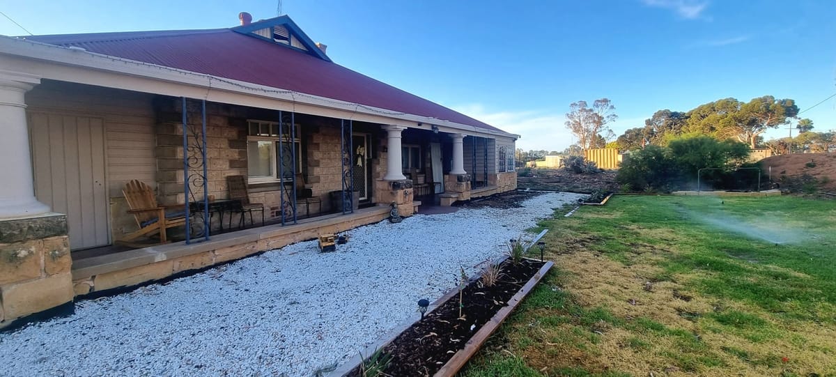A stone homestead with a long verandah and a fresh white gravel path, after an SA Elite Handyman job